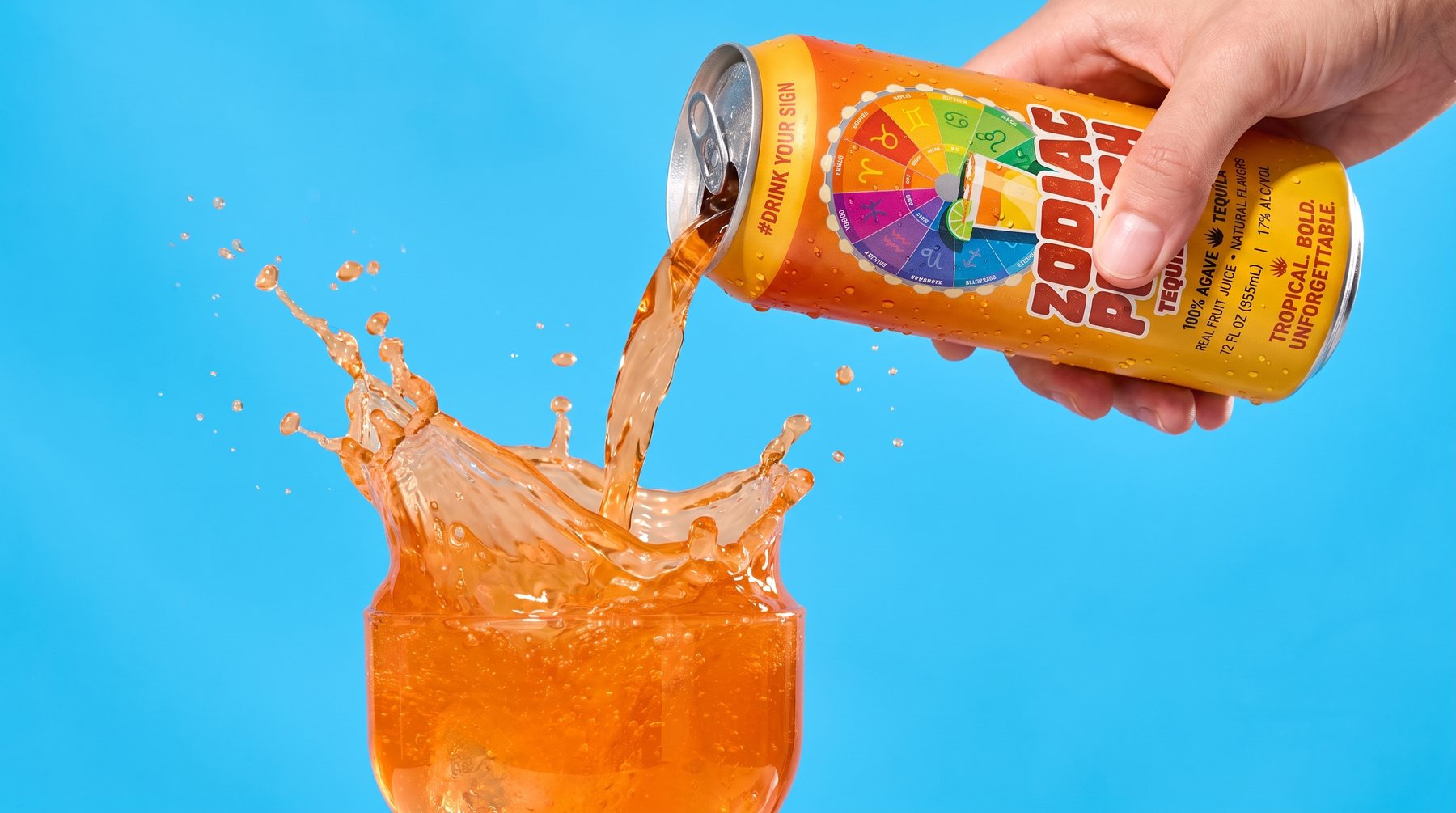 Zodiac Punch tequila punch poured from the can into an ice-filled glass